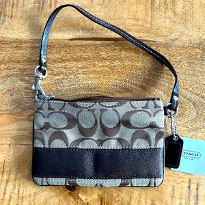 Coach NWT - wristlet monogram with brown trim and strap.